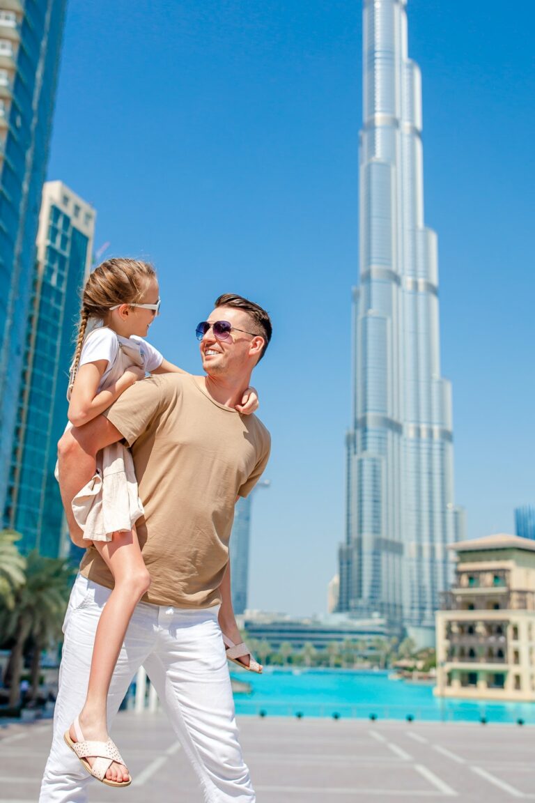 Happy family walking in Dubai with skyscrapers in the background